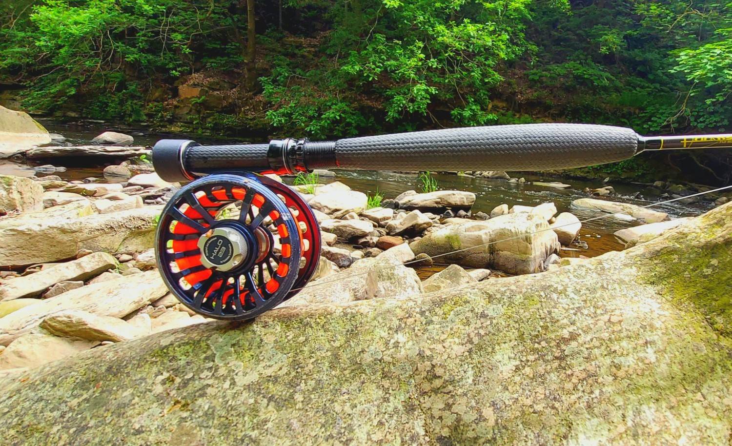 Fishing rod and reel on rocks