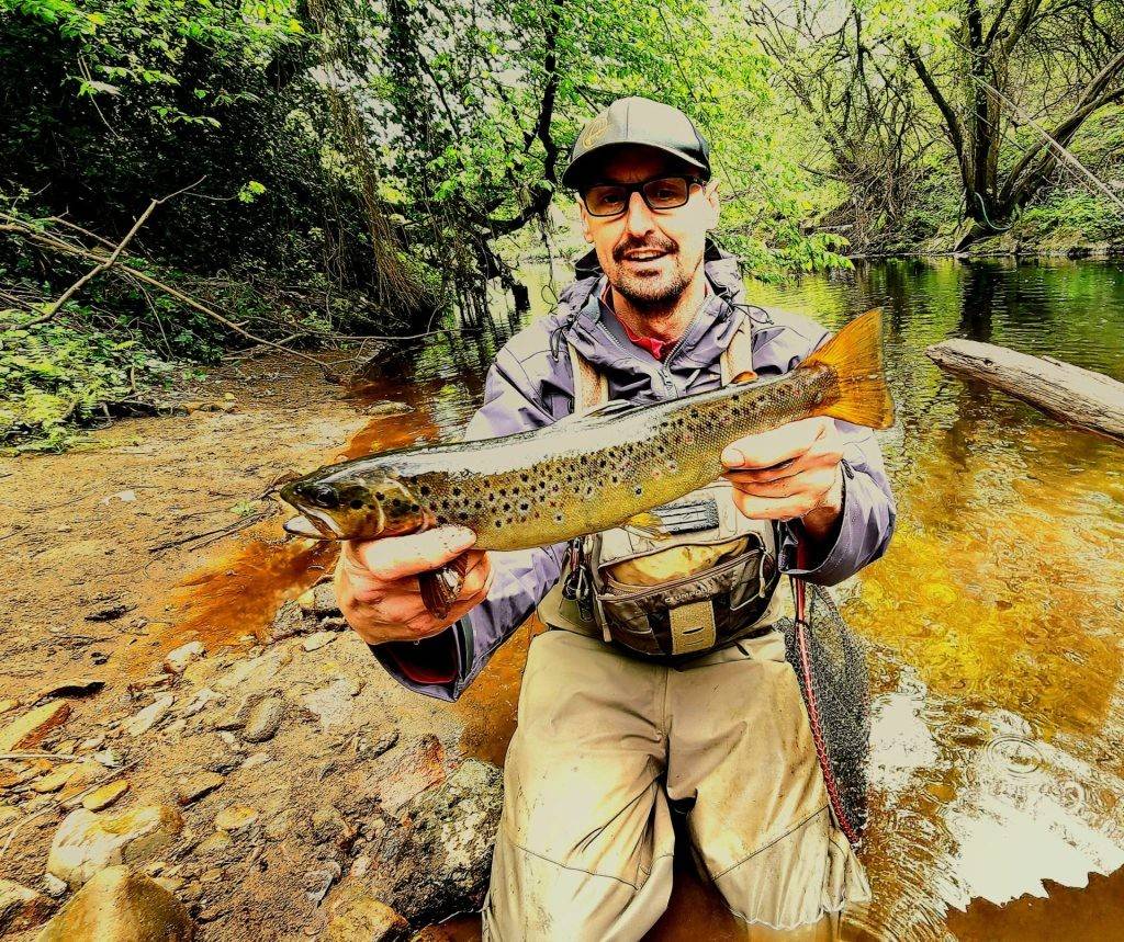 Man holding a brown trout