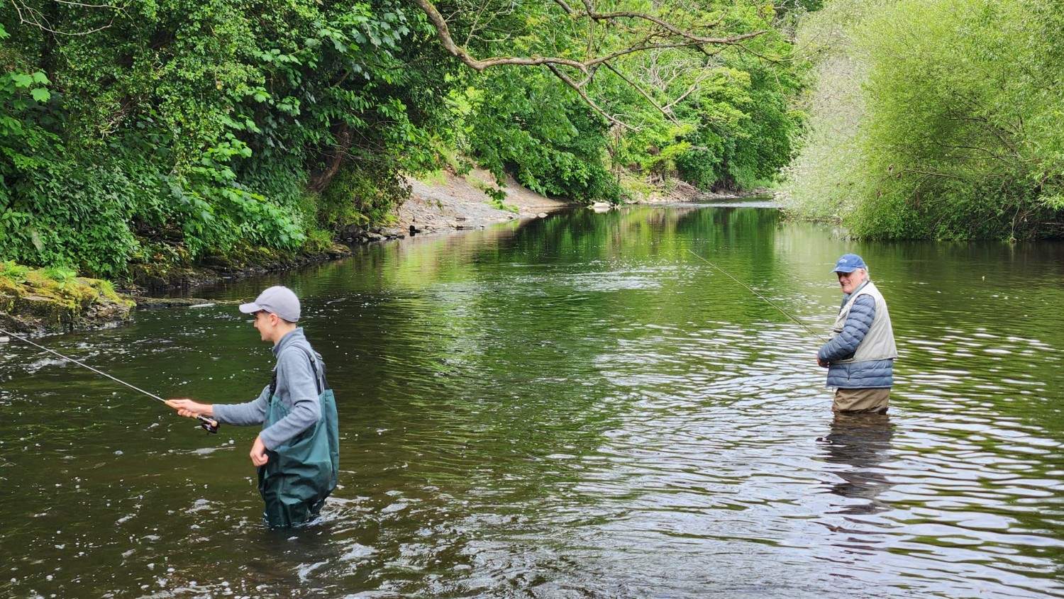 Two people fishing in water