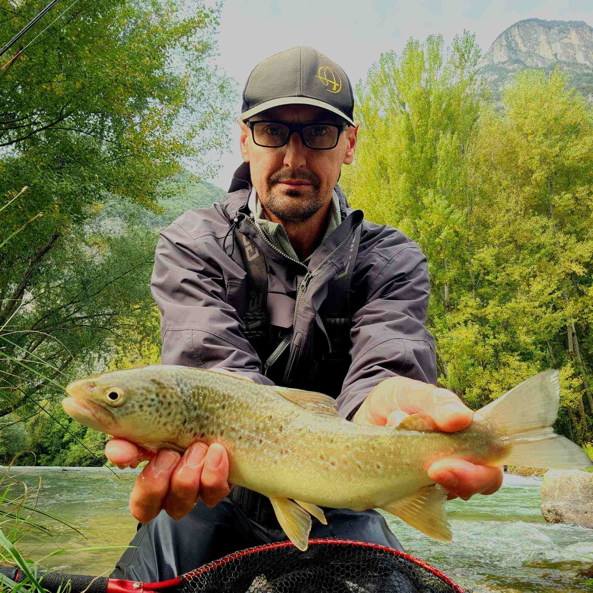 person holding gray and beige fish